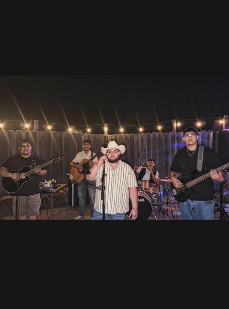 Los Hijos de Maria performing under string lights